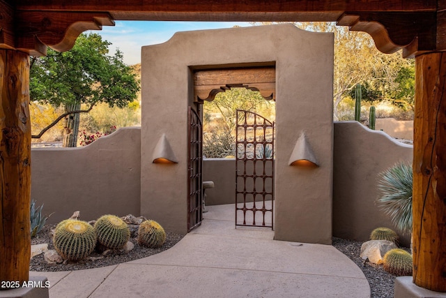 6001 E Restin Rd, Cave Creek, AZ 85331 - view of exterior entry featuring a gate and stucco siding