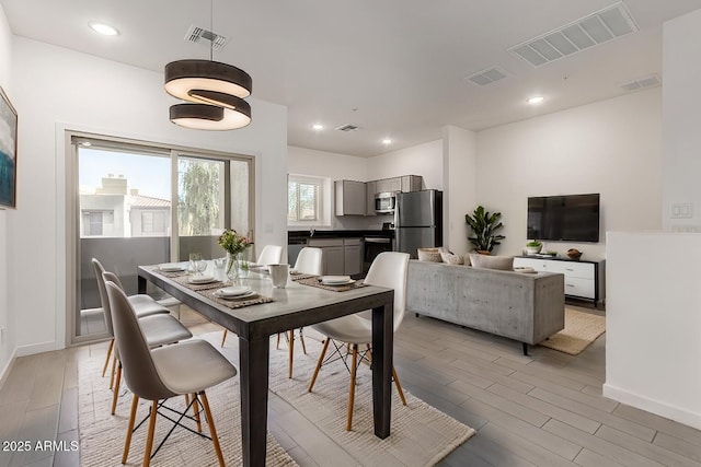 dining area featuring light wood-type flooring