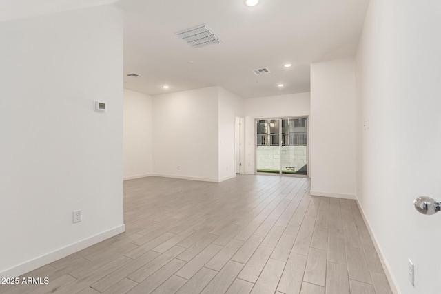 empty room with light hardwood / wood-style flooring