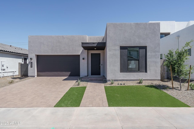 7956 W Griswold Rd, Peoria, AZ 85345 - view of front of home with a garage, decorative driveway, and stucco siding