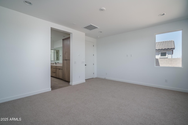 7956 W Griswold Rd, Peoria, AZ 85345 - empty room with light carpet, baseboards, recessed lighting, and a sink