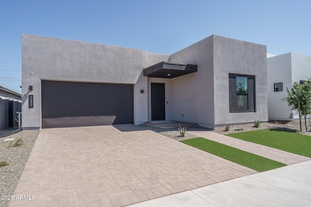 7956 W Griswold Rd, Peoria, AZ 85345 - view of front of property featuring decorative driveway, a garage, and stucco siding