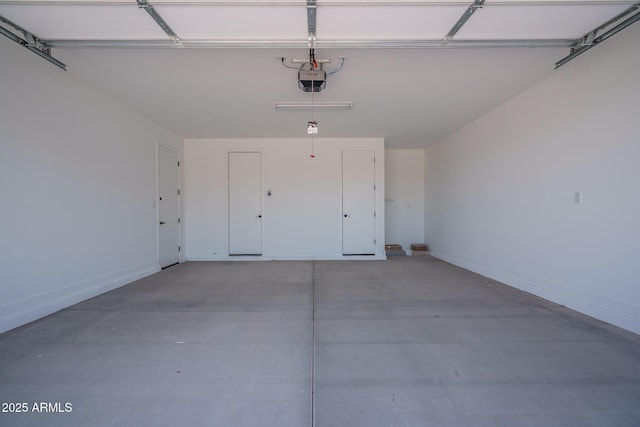 7956 W Griswold Rd, Peoria, AZ 85345 - garage featuring a garage door opener and baseboards