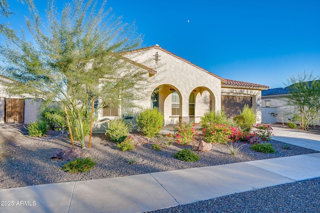 5245 N 205th Ln, Buckeye, AZ 85396 - mediterranean / spanish-style house featuring driveway, stucco siding, a tile roof, and an attached garage