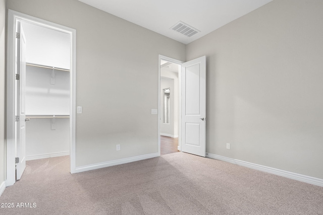 5245 N 205th Ln, Buckeye, AZ 85396 - unfurnished bedroom with a walk in closet, carpet, and visible vents