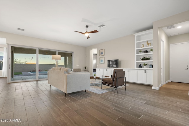 5245 N 205th Ln, Buckeye, AZ 85396 - living area with dark wood-style flooring, ceiling fan, and visible vents