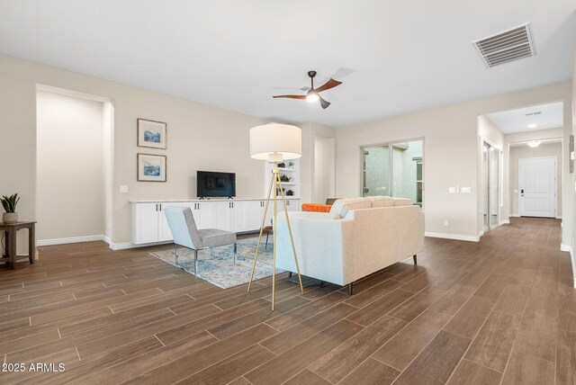 5245 N 205th Ln, Buckeye, AZ 85396 - living room featuring baseboards, visible vents, wood finish floors, and a ceiling fan
