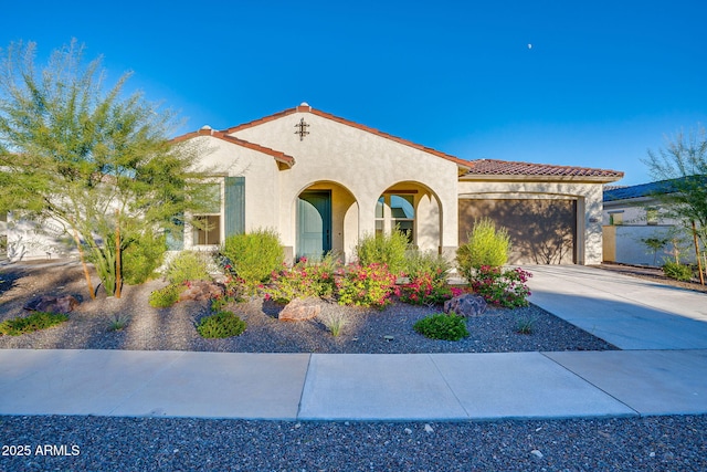5245 N 205th Ln, Buckeye, AZ 85396 - mediterranean / spanish home with a tile roof, driveway, a garage, and stucco siding