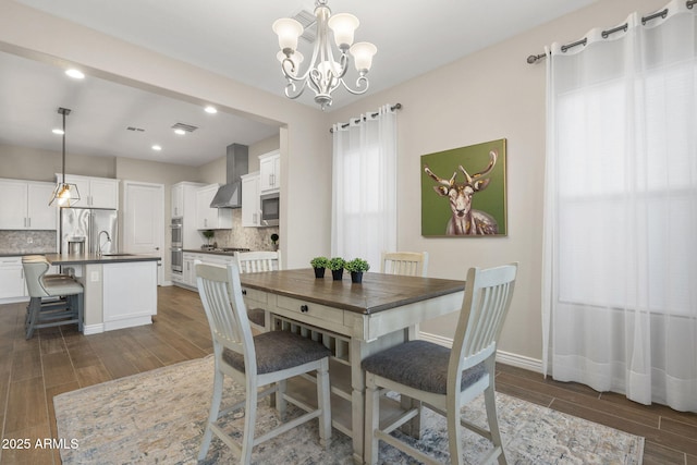 5245 N 205th Ln, Buckeye, AZ 85396 - dining space featuring visible vents, baseboards, a chandelier, and wood tiled floor