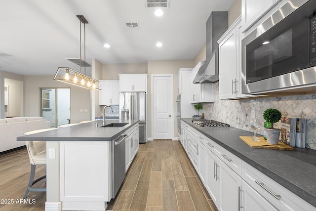5245 N 205th Ln, Buckeye, AZ 85396 - kitchen featuring a sink, dark countertops, visible vents, appliances with stainless steel finishes, and wood finished floors