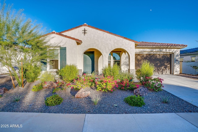 5245 N 205th Ln, Buckeye, AZ 85396 - mediterranean / spanish-style house with driveway, a tile roof, an attached garage, and stucco siding