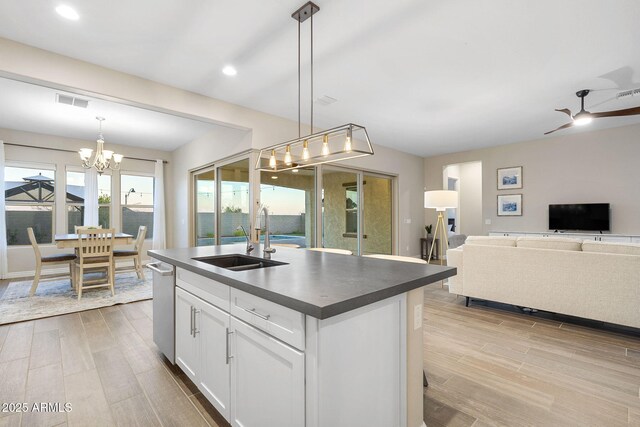 5245 N 205th Ln, Buckeye, AZ 85396 - kitchen featuring dark countertops, white cabinets, a sink, and wood finish floors