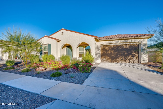 5245 N 205th Ln, Buckeye, AZ 85396 - mediterranean / spanish-style house featuring stucco siding, a tile roof, a garage, and concrete driveway