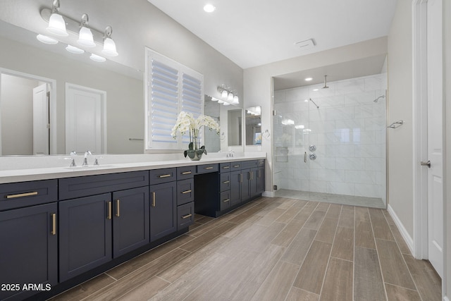 5245 N 205th Ln, Buckeye, AZ 85396 - full bath with wood finish floors, a sink, double vanity, and a walk in shower