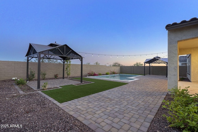 5245 N 205th Ln, Buckeye, AZ 85396 - exterior space featuring a fenced backyard, a fenced in pool, a gazebo, and a patio