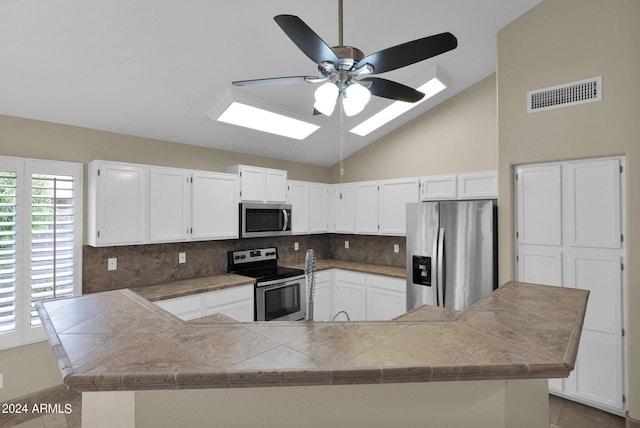 kitchen featuring white cabinetry, visible vents, backsplash, and stainless steel appliances