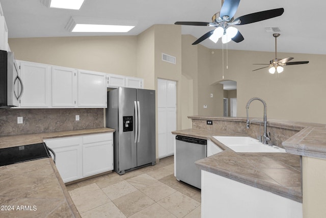 kitchen with a sink, white cabinets, visible vents, and stainless steel appliances