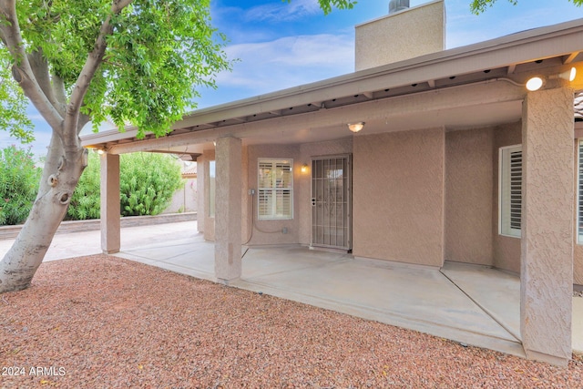 property entrance featuring a patio area and stucco siding