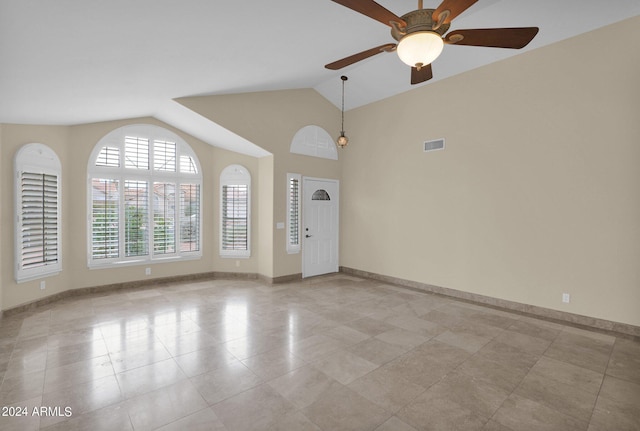 entrance foyer featuring light tile patterned floors, baseboards, visible vents, ceiling fan, and vaulted ceiling