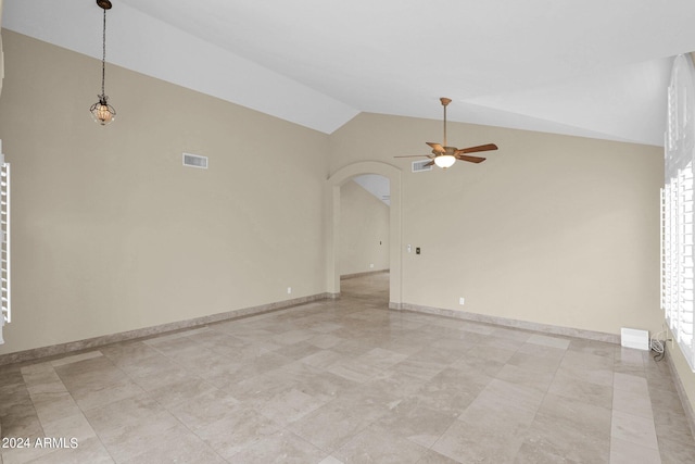 unfurnished room with visible vents, baseboards, lofted ceiling, arched walkways, and a ceiling fan