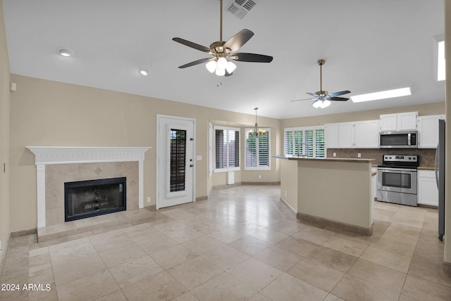 kitchen with visible vents, white cabinets, appliances with stainless steel finishes, and open floor plan