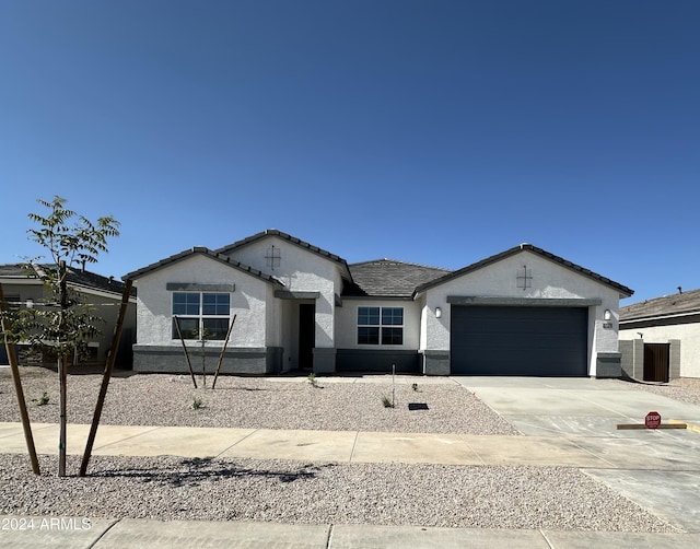 15365 W Cottontail Ln, Surprise, AZ 85387 - ranch-style house featuring stucco siding, an attached garage, concrete driveway, and central AC