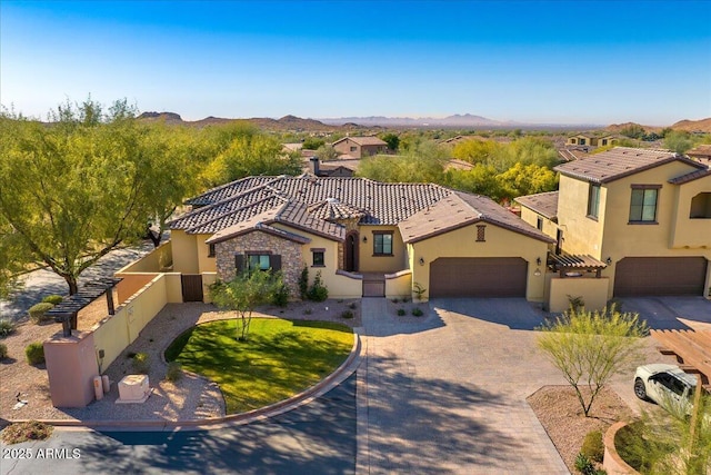 mediterranean / spanish house with a mountain view and a garage