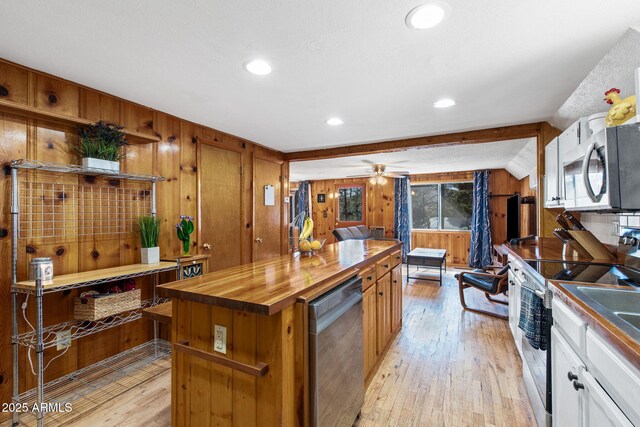 3219 N Pinewood Dr, Pine, AZ 85544 - kitchen featuring stainless steel appliances, butcher block counters, light wood-type flooring, wood walls, and a kitchen island