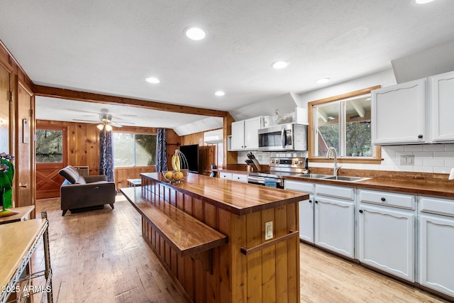 3219 N Pinewood Dr, Pine, AZ 85544 - kitchen with wooden counters, stainless steel appliances, light wood-style flooring, a sink, and wood walls