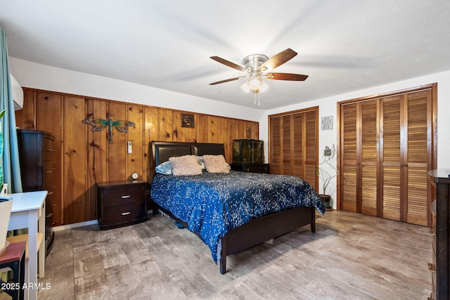 3219 N Pinewood Dr, Pine, AZ 85544 - bedroom featuring light wood finished floors, multiple closets, and ceiling fan
