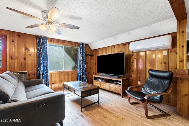 3219 N Pinewood Dr, Pine, AZ 85544 - living area with an AC wall unit, wooden walls, a textured ceiling, light wood-style floors, and a ceiling fan