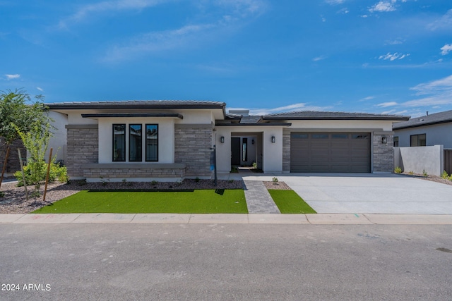 prairie-style house featuring a garage