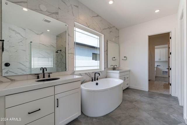 bathroom with vanity and separate shower and tub