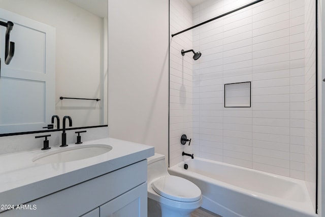 full bathroom with tiled shower / bath combo, toilet, and vanity