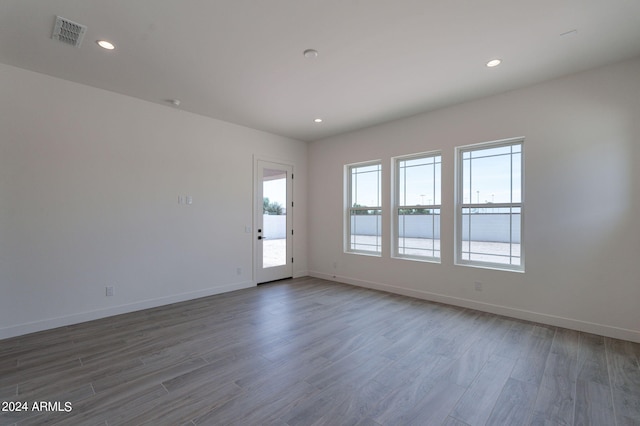 empty room with hardwood / wood-style flooring