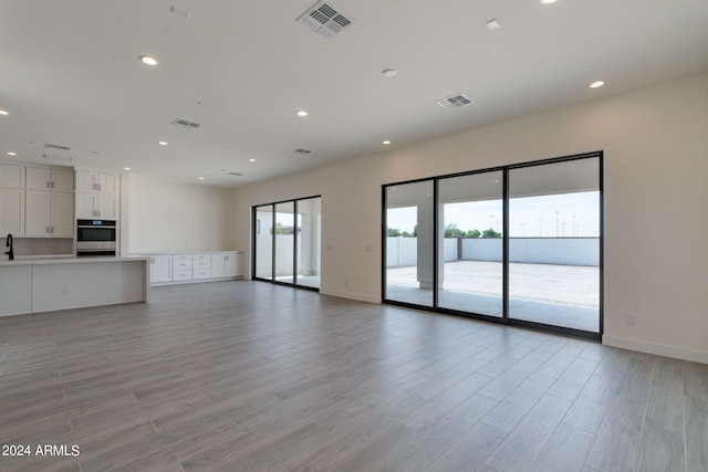 unfurnished living room featuring sink