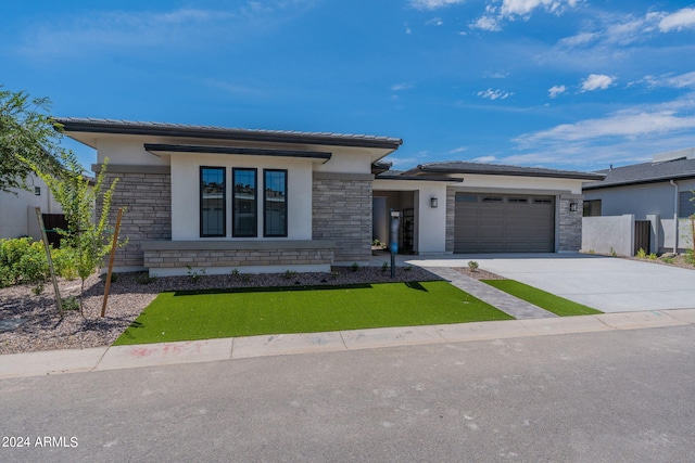 prairie-style home featuring a garage