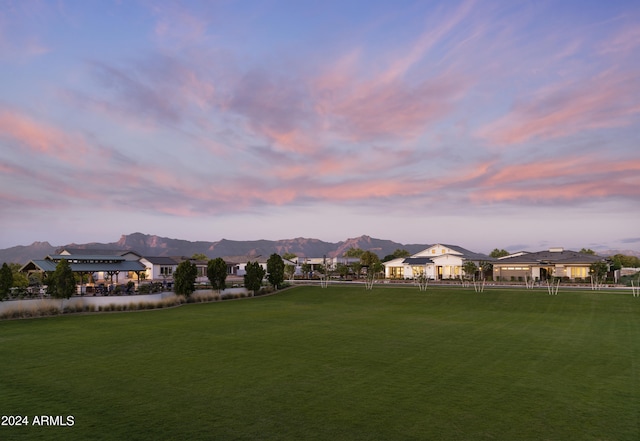 surrounding community featuring a mountain view and a yard