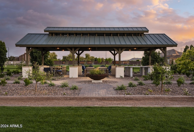 patio terrace at dusk with a gazebo and a lawn