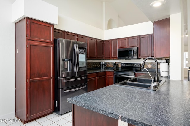 kitchen featuring backsplash, stainless steel appliances, high vaulted ceiling, and sink