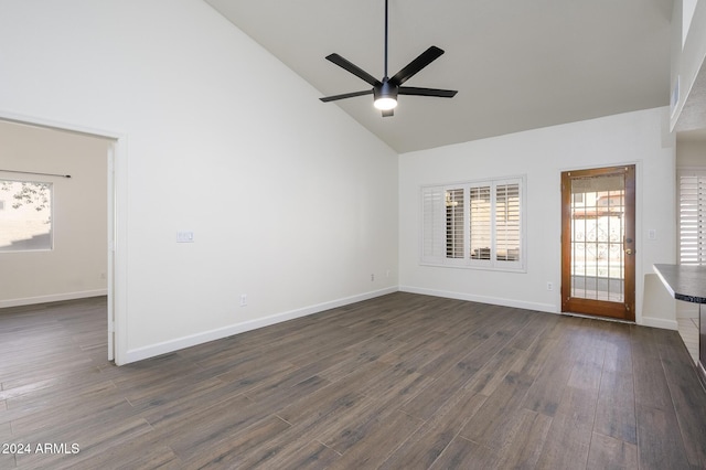 interior space featuring ceiling fan, dark wood-type flooring, and high vaulted ceiling