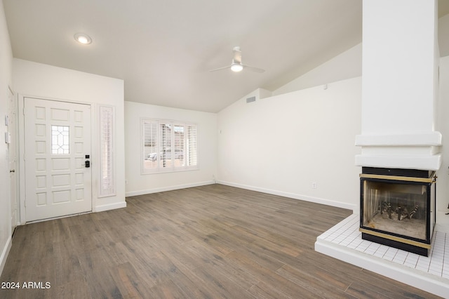 unfurnished living room featuring vaulted ceiling, ceiling fan, a multi sided fireplace, and dark hardwood / wood-style floors