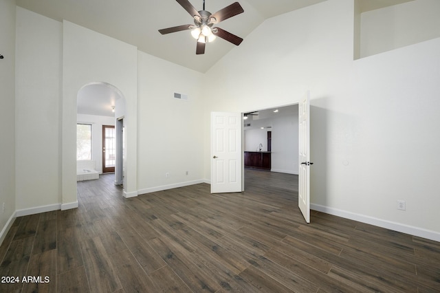 empty room with ceiling fan, dark wood-type flooring, and high vaulted ceiling