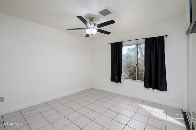 tiled empty room with ceiling fan