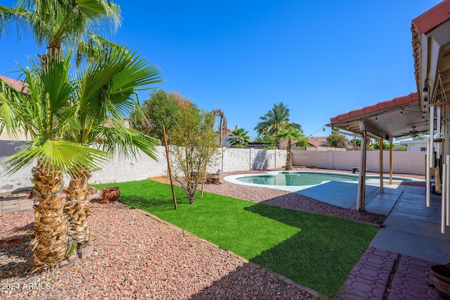 view of pool featuring a lawn