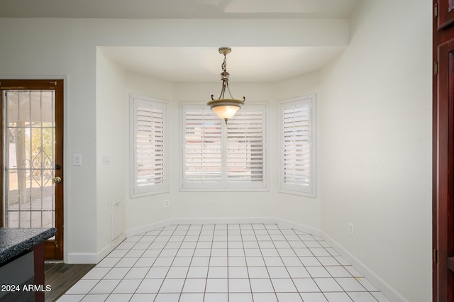 unfurnished dining area with light tile patterned floors