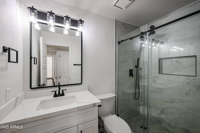 bathroom with vanity, a shower with shower door, a textured ceiling, and toilet