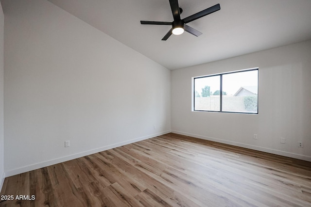 spare room featuring ceiling fan, light hardwood / wood-style flooring, and lofted ceiling
