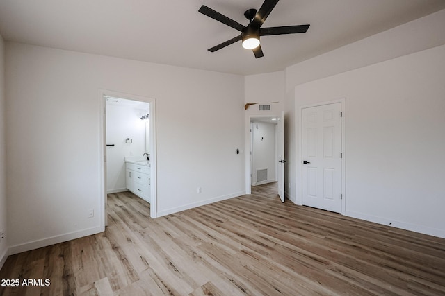 unfurnished bedroom with a closet, connected bathroom, light hardwood / wood-style floors, and ceiling fan