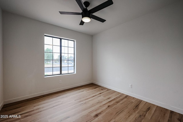 empty room with ceiling fan and light hardwood / wood-style flooring